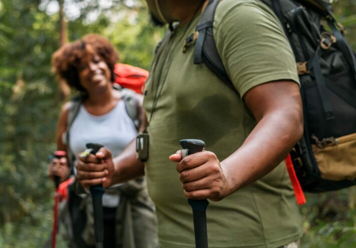 two people trekking in the forest